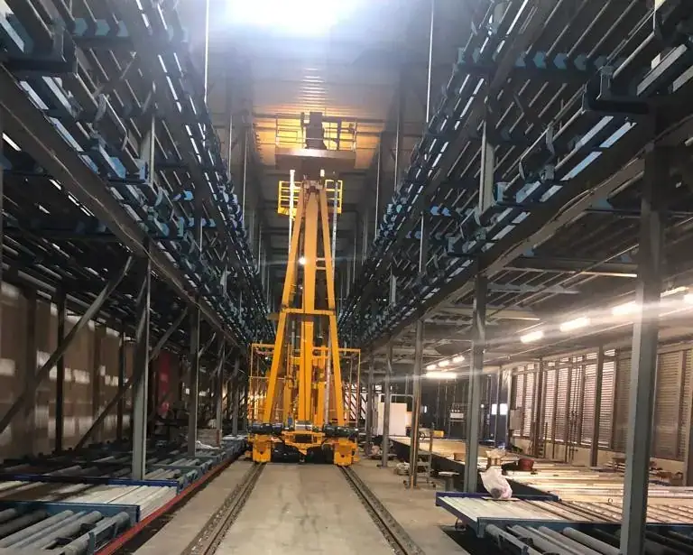 Yellow elevating transfer vehicle between multi-level ULD storage decks at the FCS cargo facility, Frankfurt Airport, Germany